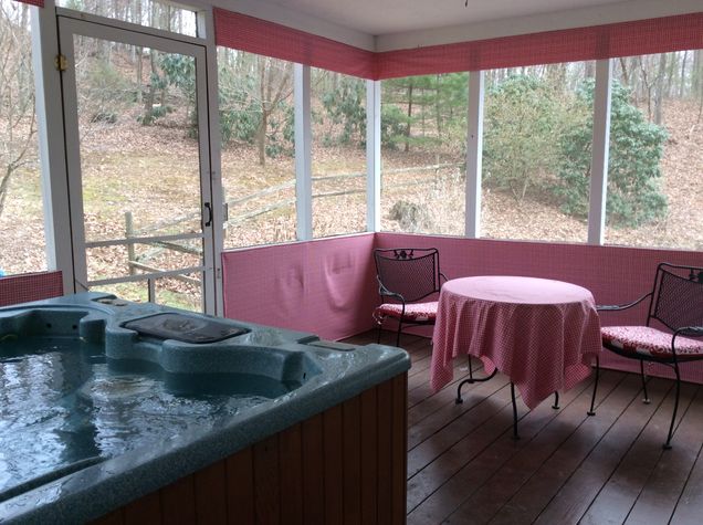 5 person hot tub on screened in porch. Bistro set for visiting and enjoying a refreshment.