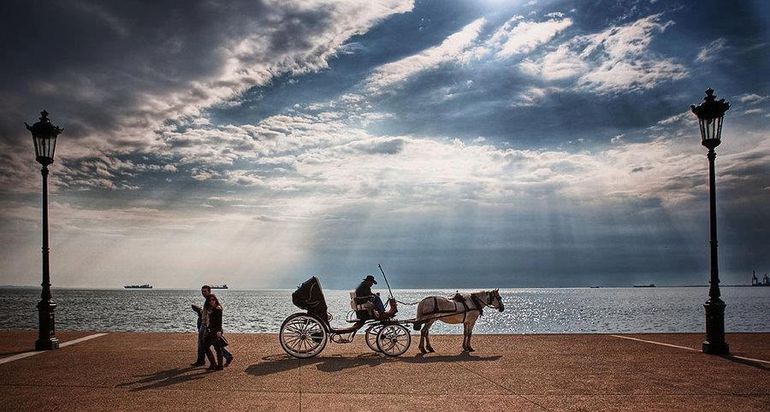 Horse carriage on the pier under the clouds