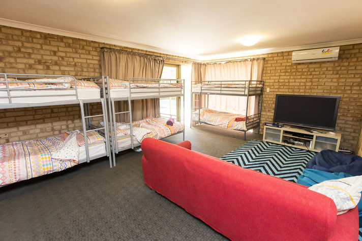 Guest lounge area with 3 x single bunk beds and a sofa bed (pictured sofa isn't a sofa bed)