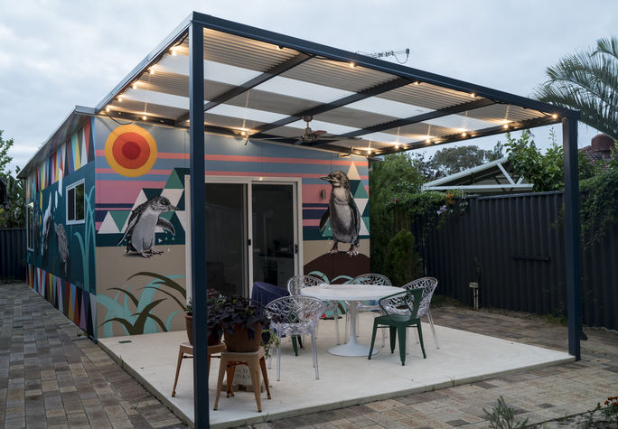 Festoon lights light up the patio area of the granny flat.