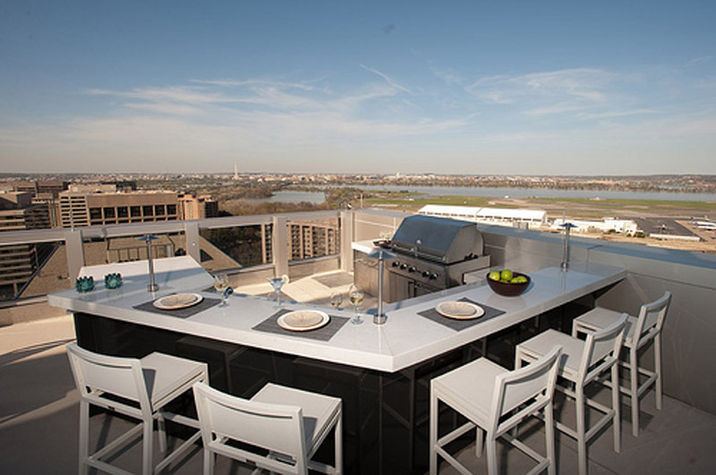 The rooftop deck offers an outdoor dining space and BBQ grill with expansive city views.