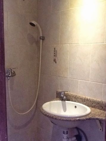 Bathroom with shower and hand wash basin