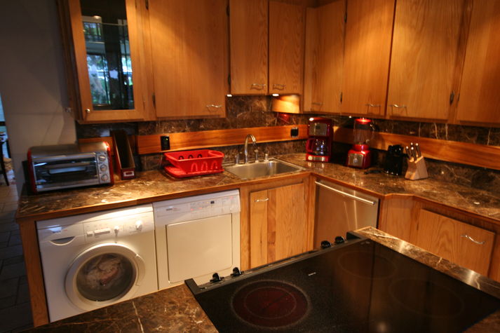 Washere/Dryer left dishwasher right with island stove.