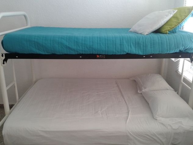 Litera de cama individual y cama matrimonial, ventanas con cortinas y A/C cuarto 3.