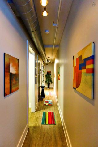 The long hallway doubles as an art gallery.