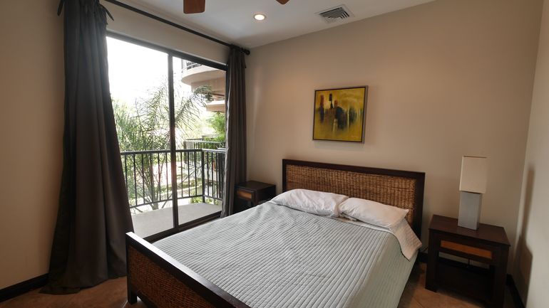 First Bedroom with Double Bed, Linen, Patio overlooking swimming pool, Air conditioner and ceiling fan
