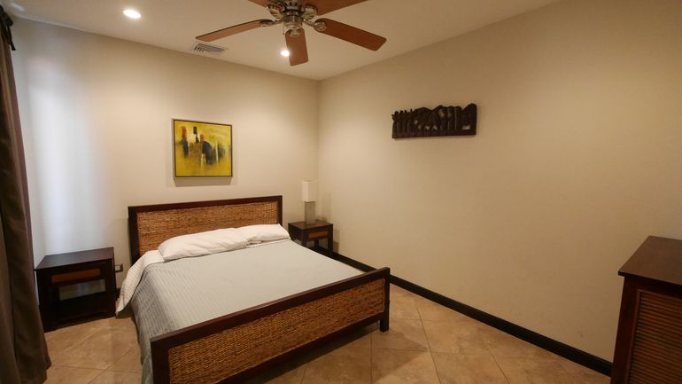 First Bedroom with Double Bed, Linen, Patio overlooking swimming pool, Air conditioner and ceiling fan