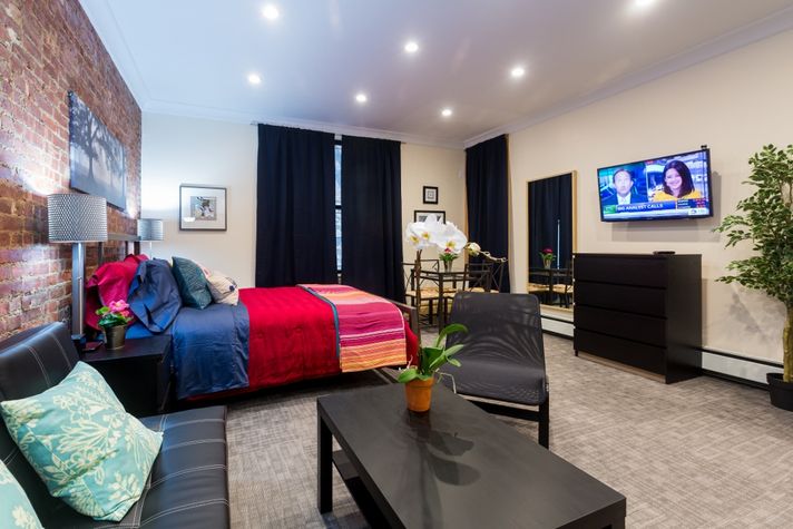 Overview of studio living area with seating area in foreegroun