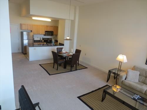 Living room with kitchen conveniently opened to the dining area
