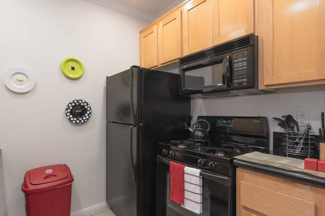 Whirlpool appliances w/ custom maple wood cabinets