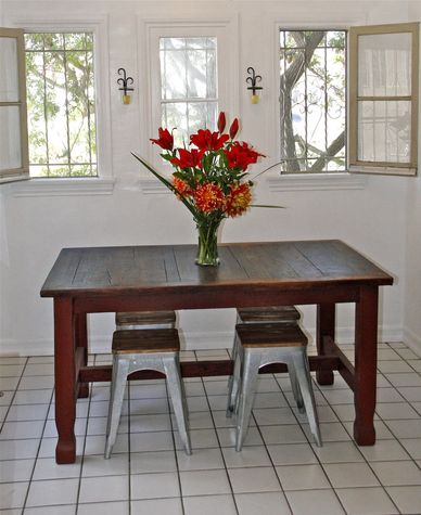 Heavy reclaimed wood farm table with industrial stools