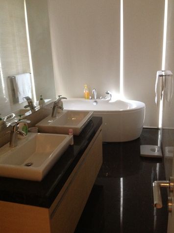En suite bathroom to master bedroom with tub, separate rainfall shower, double sinks and toilet in alcove
