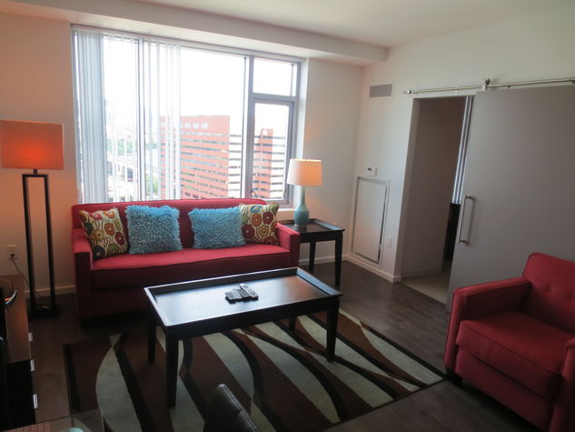 Comfortable living room with pullout sofa bed and club chair