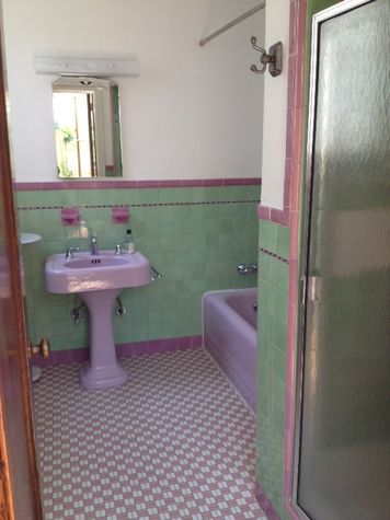 Bathroom with shower over tub and sink