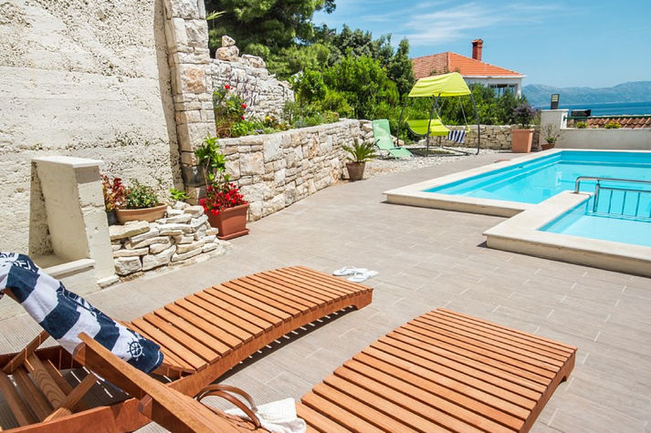 Grab a book and lie down on a deck chair while your kids are playing in the pool