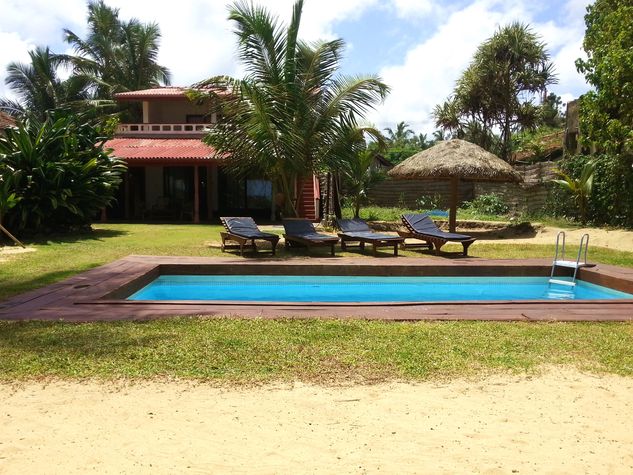 The beach house and front garden as viewed from in front of the swimming pool