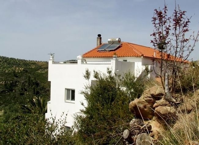 Villa Elleftheria built into the hillside.