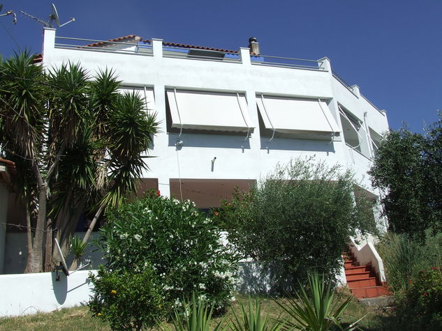 The Villa viewed from the garden. The Villa House apartment occupies the whole of the middle floor