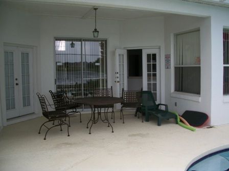Lanai with patio furniture and loungers