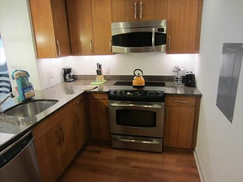 Fully equipped kitchen with full size stainless steel appliances, pots, pans and dishes