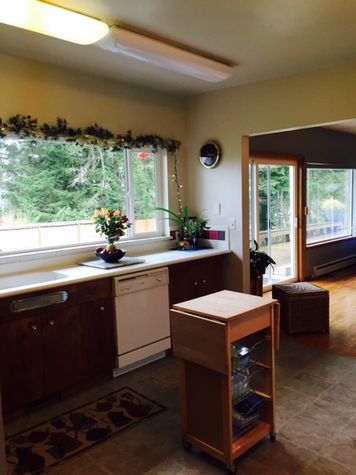 Kitchen overlooks the yard with pretty flowers, vegetables and lots of birds!