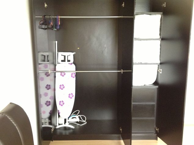 Iron, iron board in the wardrobe